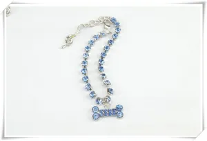 Detail shot of light blue rhinestone pet collar with a sparkling bone shaped pendant