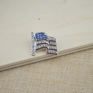 Detailed close-up of American flag brooch with sparkling rhinestones and enamel finish