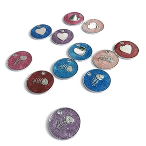 Glittering round pet ID tags with fishbone and heart patterns in various colors