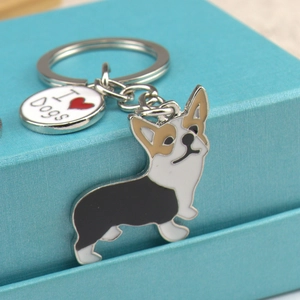 Cute Corgi metal keychain with I Love Dogs tag on a gift box background