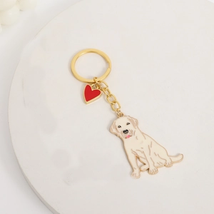 Golden Labrador keychain with a red heart charm and white dog pendant on metal ring