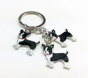 Detail of Boston Terrier metal keychain featuring three dog charms with enamel finish