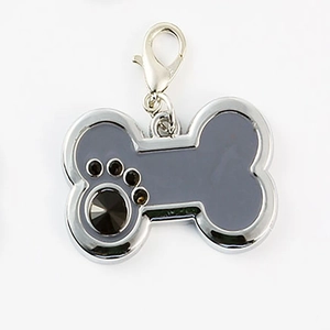 Macro detail of bone-shaped pet tag with grey enamel and black rhinestone paw print