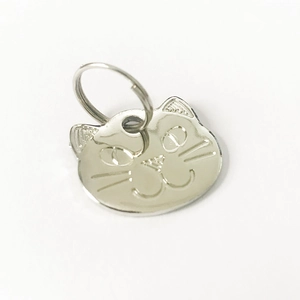 Close-up of cat-shaped zinc alloy pet ID tag with engraved whiskers and split ring