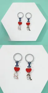Detail of cute cat couple keychains with colorful enamel heart and alloy pendants