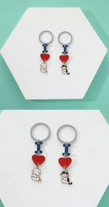 Close-up of cute DIY cat keychain set with blue letter and red enamel heart charms