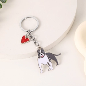 Detail view of Pitbull and red heart enamel charms on a silver metal keychain