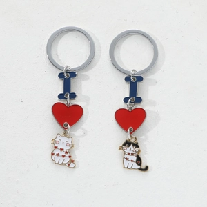 Cute DIY alloy cat and heart enamel keychain set for couples on a white background