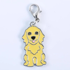 Detail of cartoon Golden Retriever metal keychain with yellow enamel and silver lobster clasp