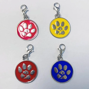 Detail of round pet ID tags with paw prints in pink, yellow, red, and blue colors