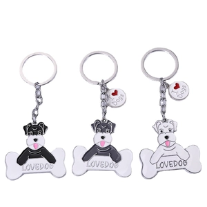 Trois porte-clés Schnauzer en métal noir, gris et blanc avec breloque en forme d'os