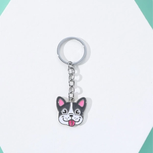 Cartoon French Bulldog enamel keychain with silver metal ring on white display stand