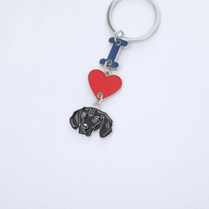 Detailed view of enamel keychain with I love dog pendants including a black lab and red heart