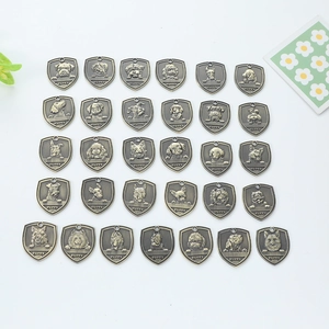 Set of 29 antique bronze dog ID tags in shield shape with embossed pet portraits