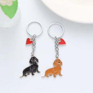 Detail view of black and brown dachshund dog keychains with red heart charms