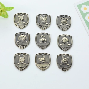 Antique bronze shield-shaped dog ID tags with 3D embossed puppy breeds and floral accents