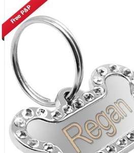Detail of silver bone-shaped pet ID tag with rhinestones and Regan engraving