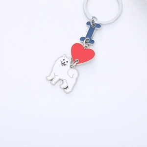 Detail of keychain featuring white Samoyed dog, red heart, and blue letter enamel charms