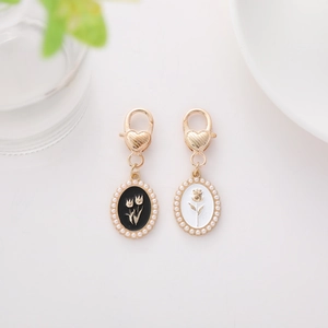 Detail of vintage oil-dripping floral pendants with pearls and golden lobster clasps