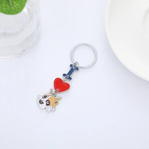 Cartoon dog keychain with blue bone and red heart charms on a minimalist white background