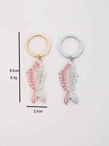 Detailed macro view of enamel dolphin whale keychain charms with lobster clasp