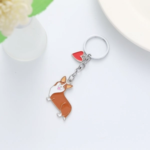 Cute Corgi dog keychain with red heart charm and polished silver ring on white background