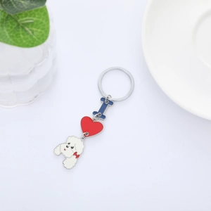 Detail view of poodle keychain with enamel heart and letter charms on silver metal ring