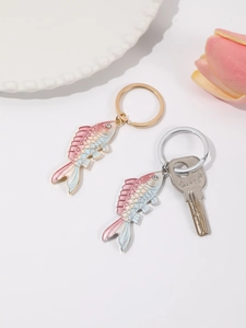 Detailed close-up of gradient enamel fish keychain with sparkling rhinestone eyes