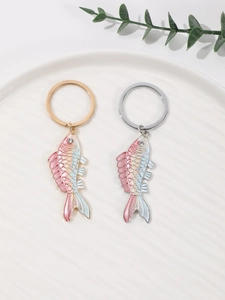 Detail of enamel koi fish keychains with gradient colors and sparkling rhinestone eyes