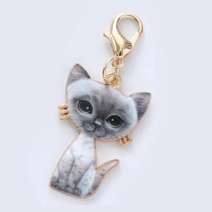 Close-up of cute grey cat keychain charm with realistic print and gold lobster clasp