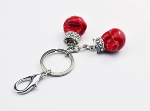Detail view of red boxing glove keychains with sparkling rhinestone wrist accents