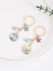 Detailed macro view of ocean-themed resin keychains with miniature sand and shells