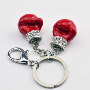 Detailed close-up of red boxing glove keychains with sparkling rhinestone wrist accents
