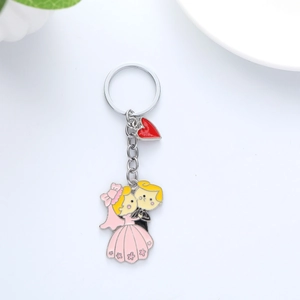 Cartoon metal wedding keychain with bride bridegroom pendants and a red heart charm