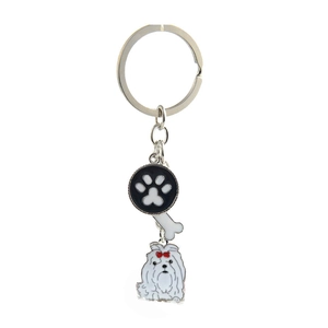 Close-up of metal pet keychain with dog paw charm, white bone, and cute dog detail