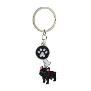 Detail of metal keychain featuring a black French bulldog, white bone, and paw print pendant