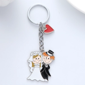 Cartoon bride and groom metal couple keychain with a small red heart charm for wedding gift