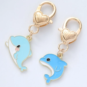 Detail of blue dolphin pendants with gold lobster clasps and enamel finish