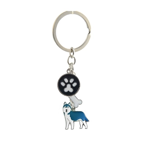Close-up of metal keychain with dog paw print, white bone and enamel husky charms