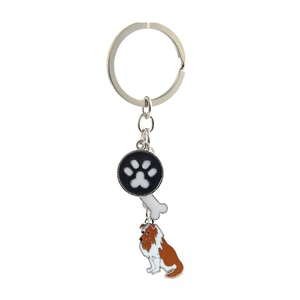 Detailed view of metal pet keychain with dog paw, bone charms and collie dog pendant