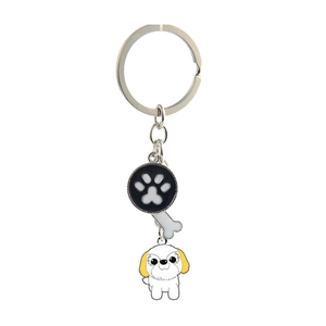 Detailed view of silver keychain with black dog paw, bone, and shih tzu puppy pendants