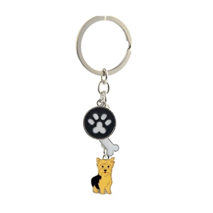 Detail of metal paw print and dog charms on keychain with white bone and Yorkshire pendant