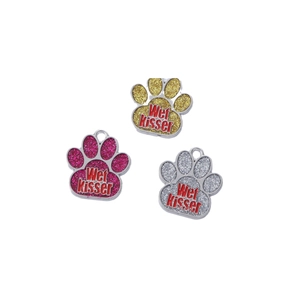 Glitter paw-shaped pet ID tags in rose red, gold, and silver with Wet Kisser text