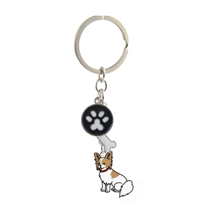 Detail of metal pet keychain featuring paw print, bone shape, and dog pendant charms