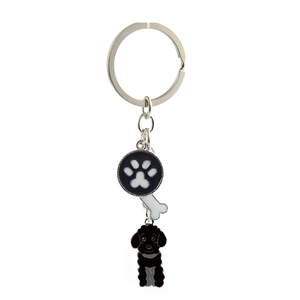 Detail view of metal pet keychain with paw print, dog bone and black poodle charms
