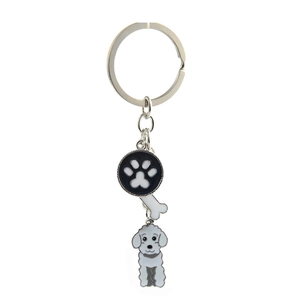 Detail of metal keychain with paw print charm, bone pendant and white poodle dog figure