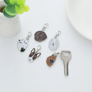 Set of five metal cartoon dog charms with lobster clasps for keychains and bag decor