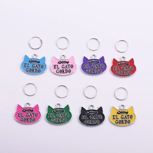 Detail view of colorful fishbone engraved metal cat tags in eight vibrant paint finishes