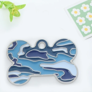 Detailed view of bone-shaped pet ID tag with blue camo enamel and metal frame