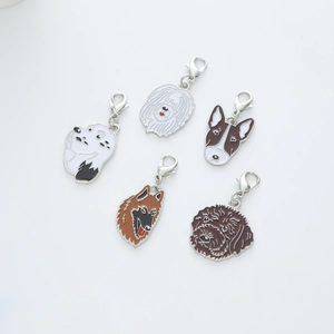 Close-up of five colorful enamel dog charms with silver lobster clasps on a white background